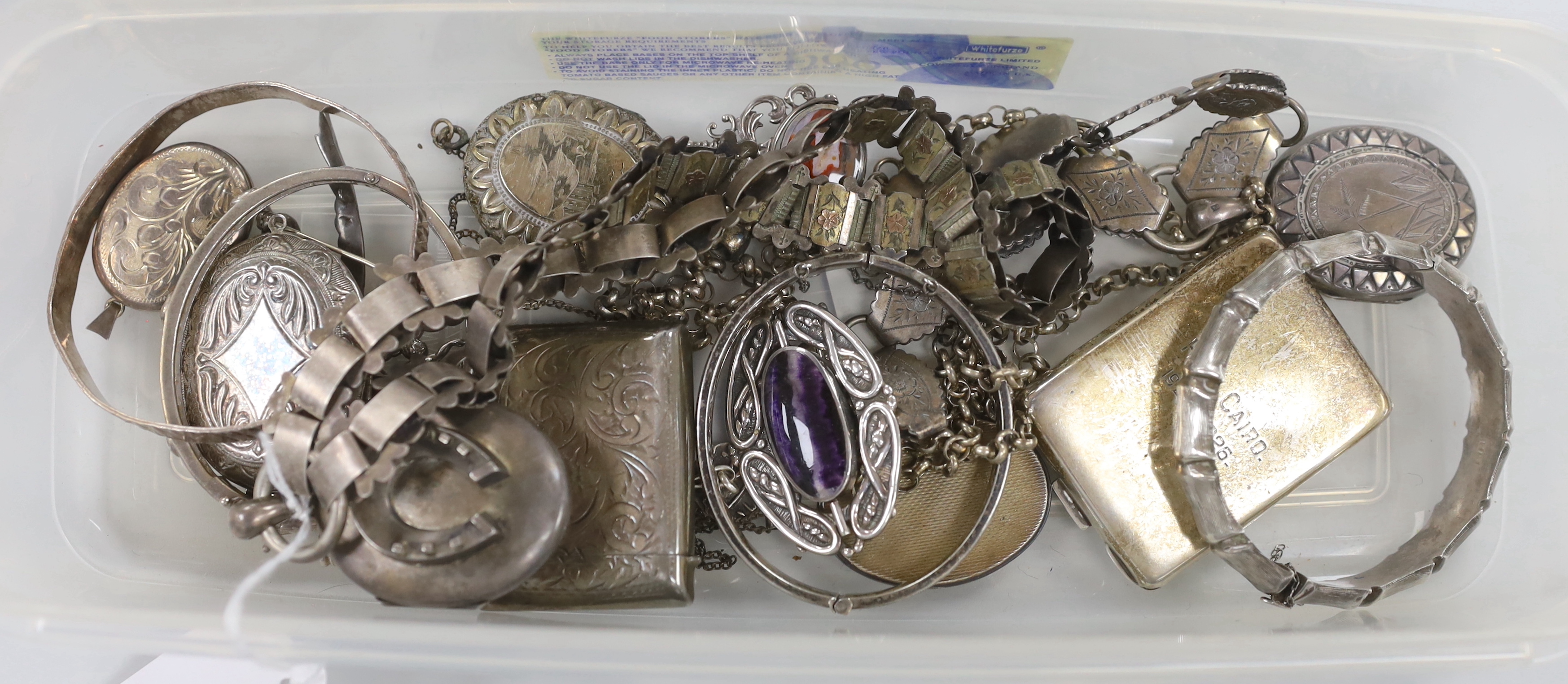 A Victorian silver oval locket, on a white and yellow metal chain, overall 52cm and other jewellery including silver and white metal lockets, vest case etc